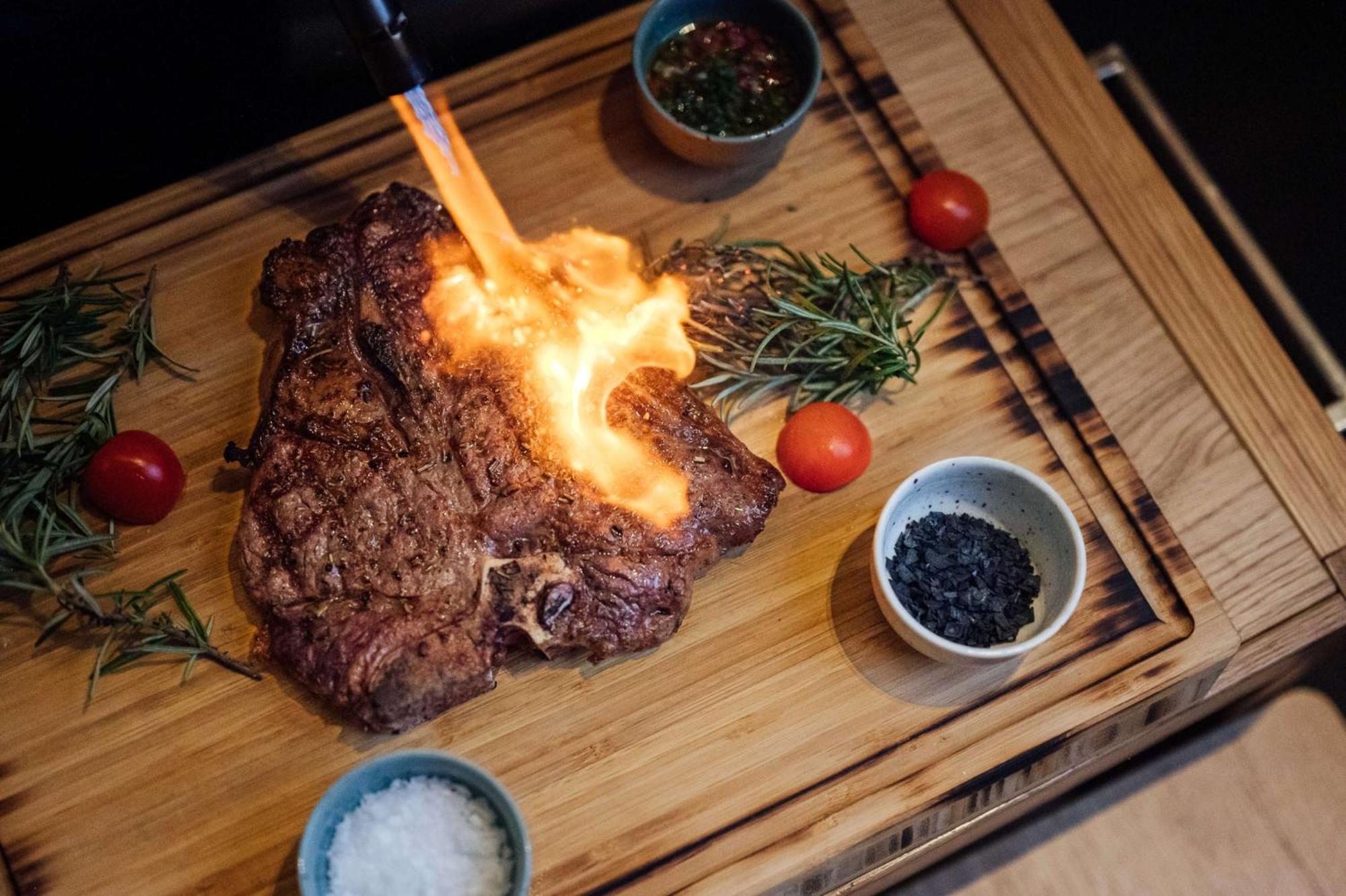 Radisson Blu Hotel Bucharest Exterior photo A steak being flamed